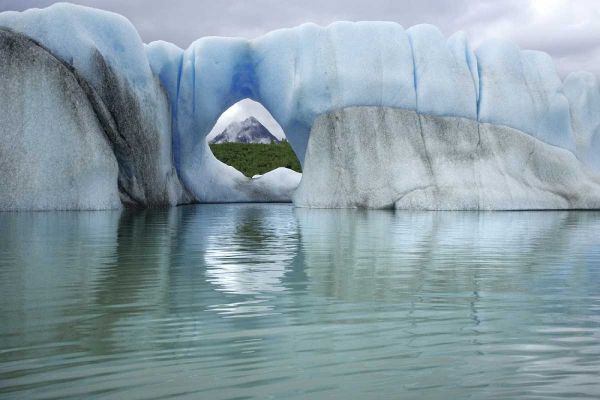 AK, Alsek Lake Mountain through hole in iceberg